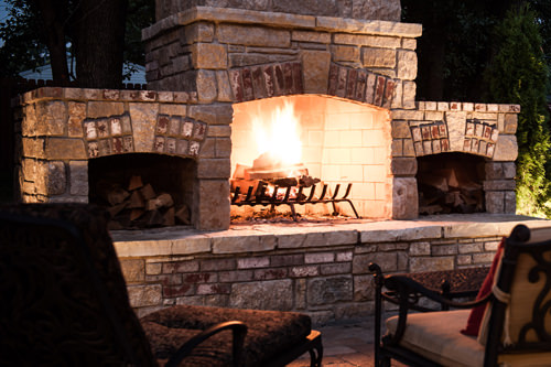 Outdoor fireplace burning real wood logs.